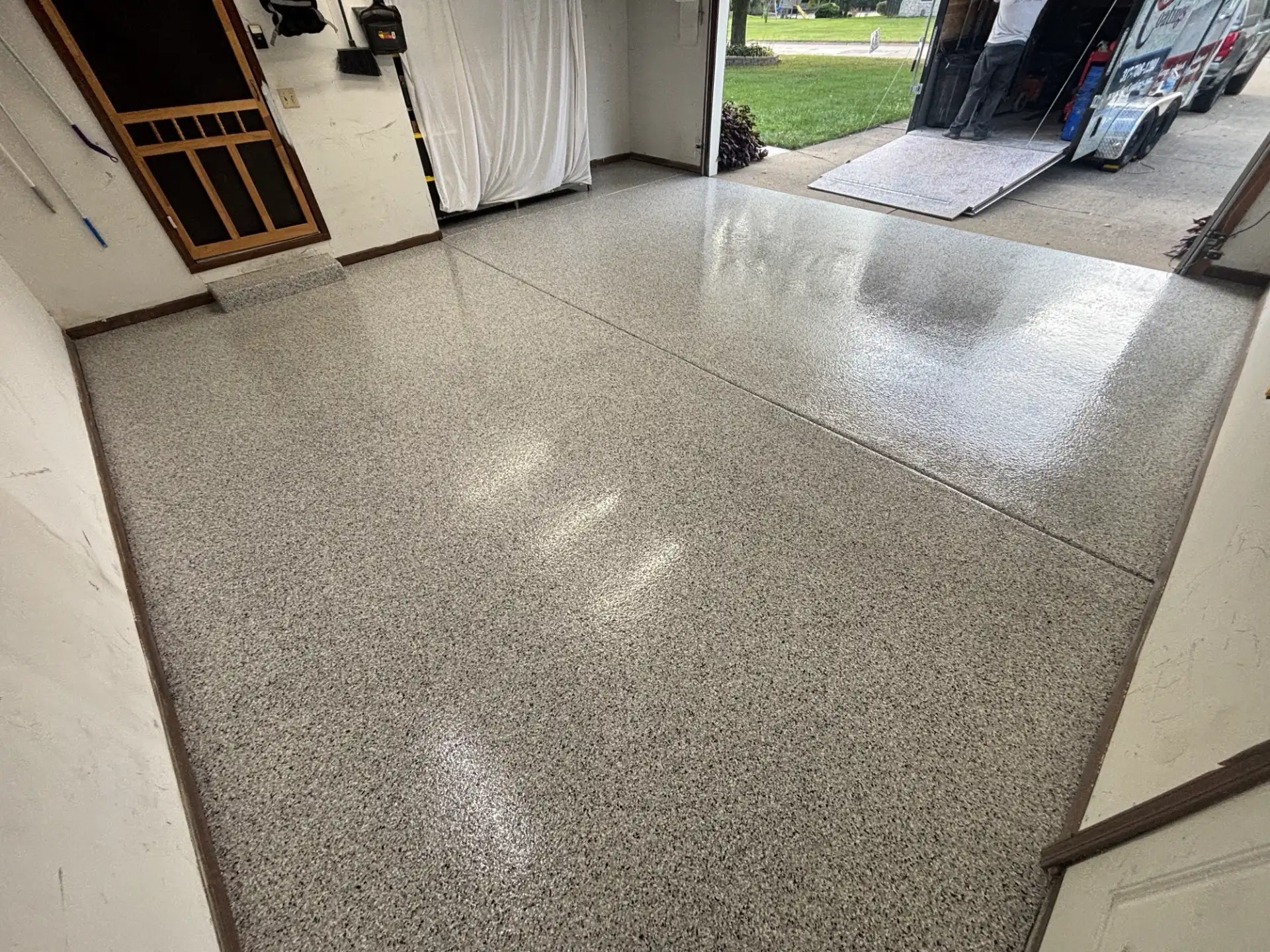 Glossy flake garage floor coating with clear polyaspartic topcoat