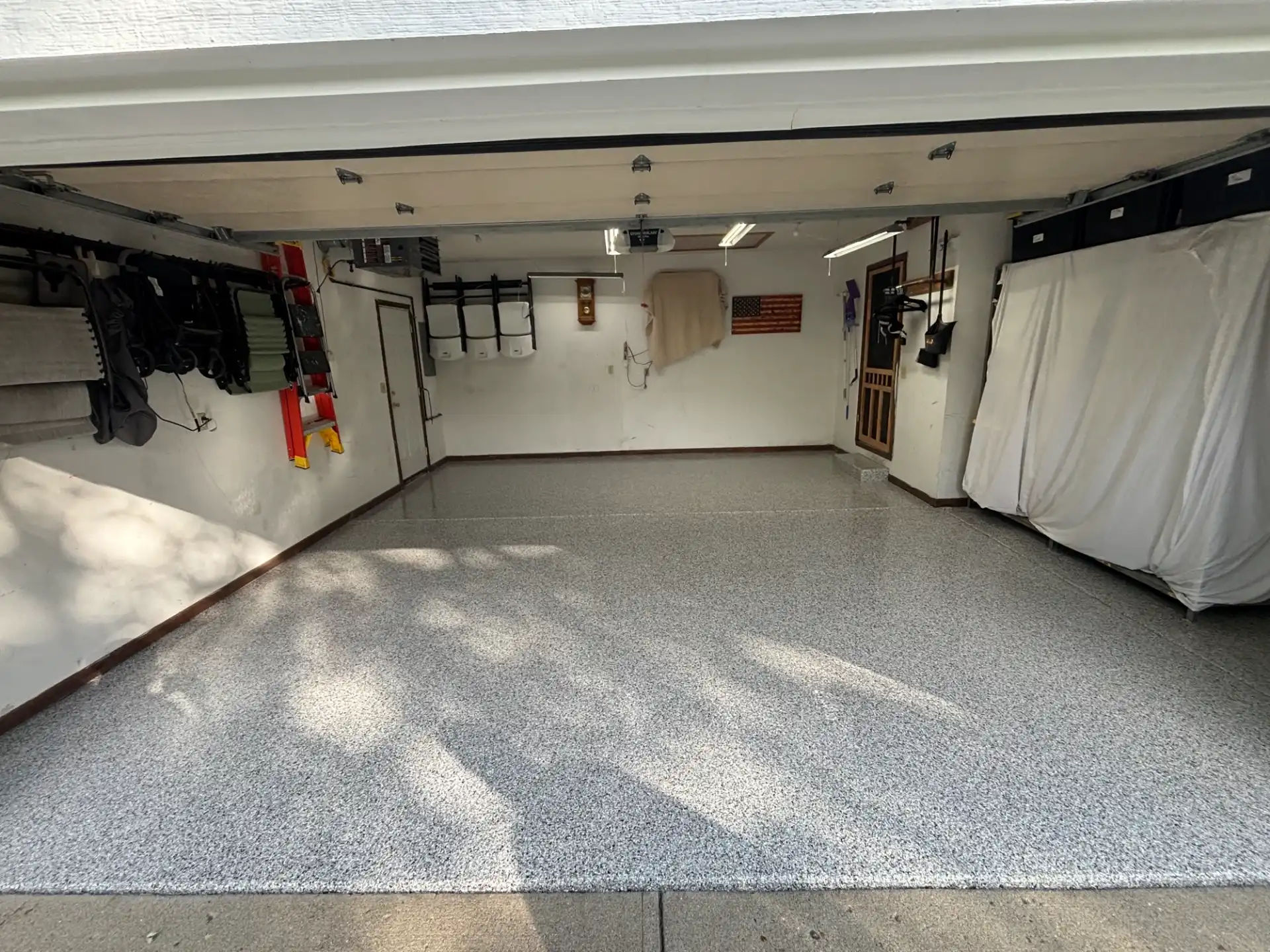 Finished gray flake polyaspartic garage floor coating by Guy Coatings