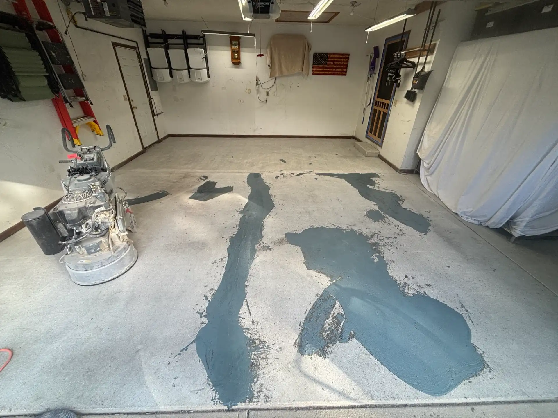 Cracks and divots patched on ground garage concrete before base coat