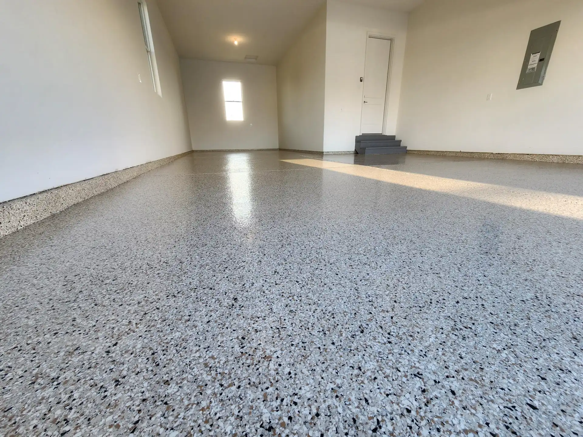 Full broadcast vinyl flake garage floor coating with polyaspartic topcoat installed by Guy Coatings in Indianapolis Indiana