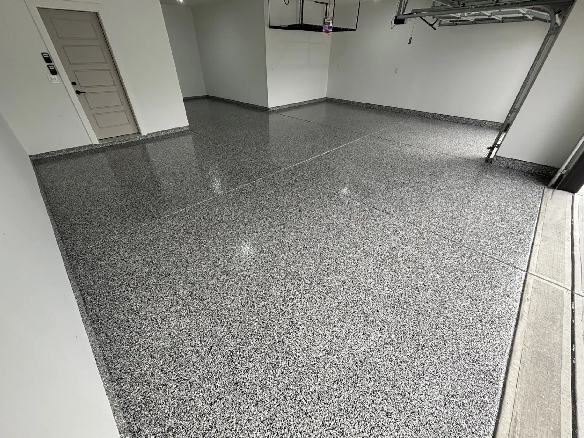 McCordsville garage floor after gray flake polyaspartic coating with glossy finish