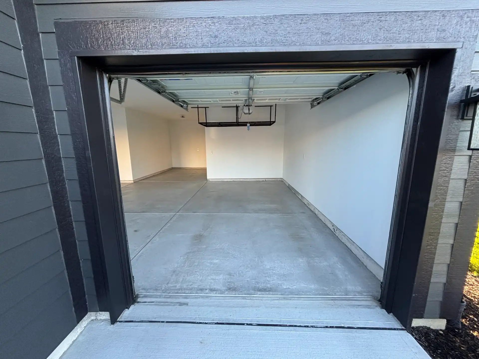 McCordsville garage before coating, bare concrete floor seen from the driveway