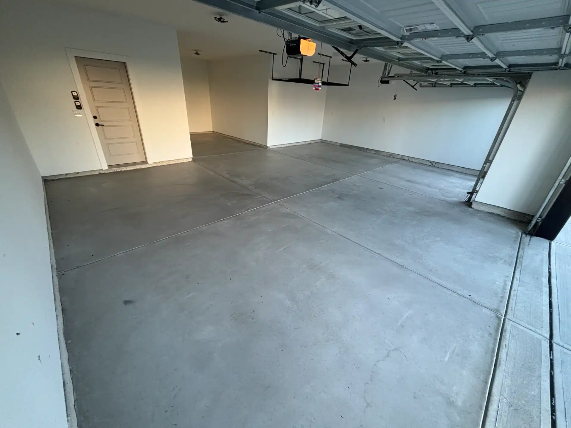 McCordsville garage floor before coating, showing stained and cracked concrete