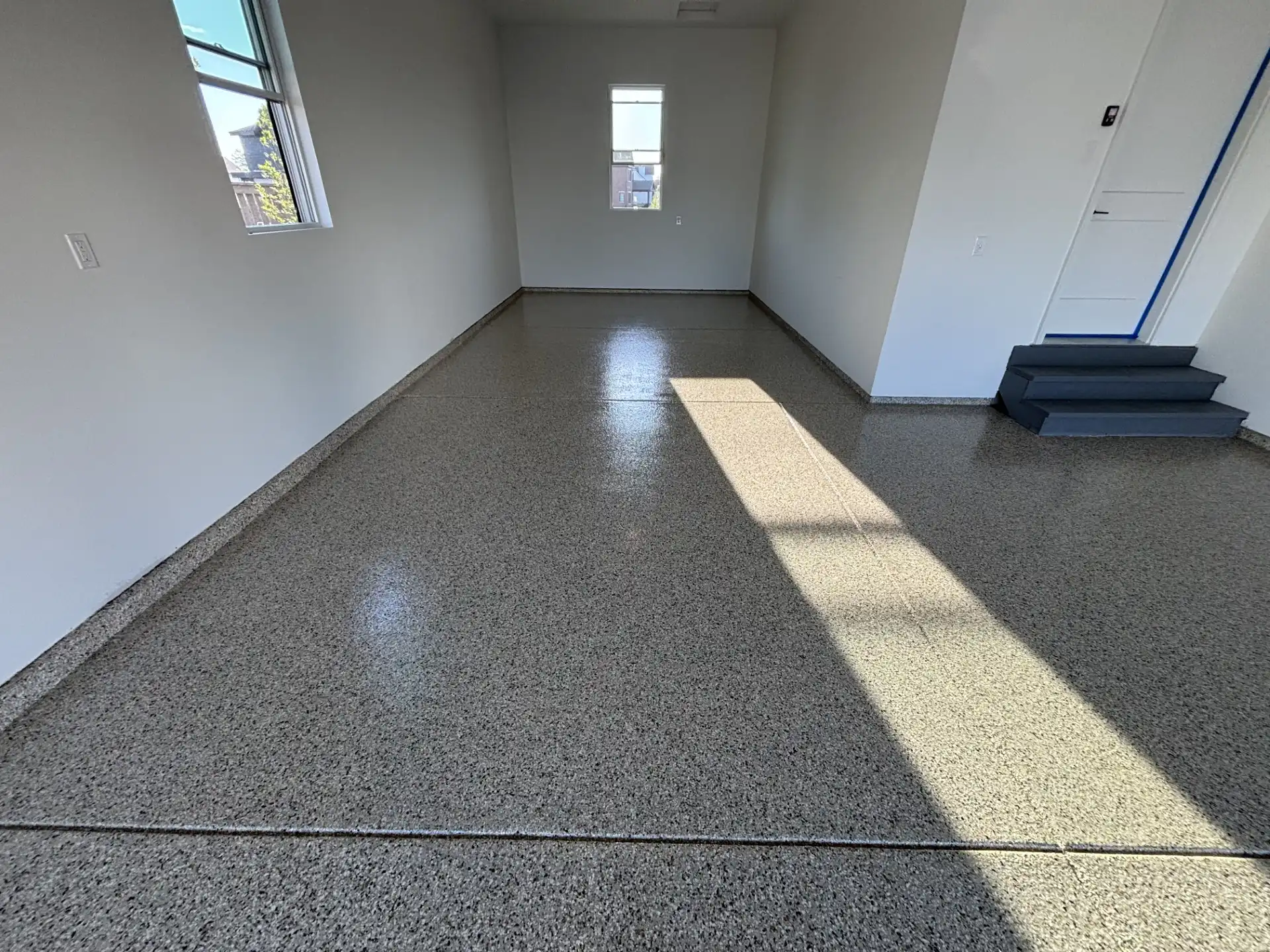 Gray flake polyaspartic garage floor coating in McCordsville and Geist, Indiana by Guy Coatings