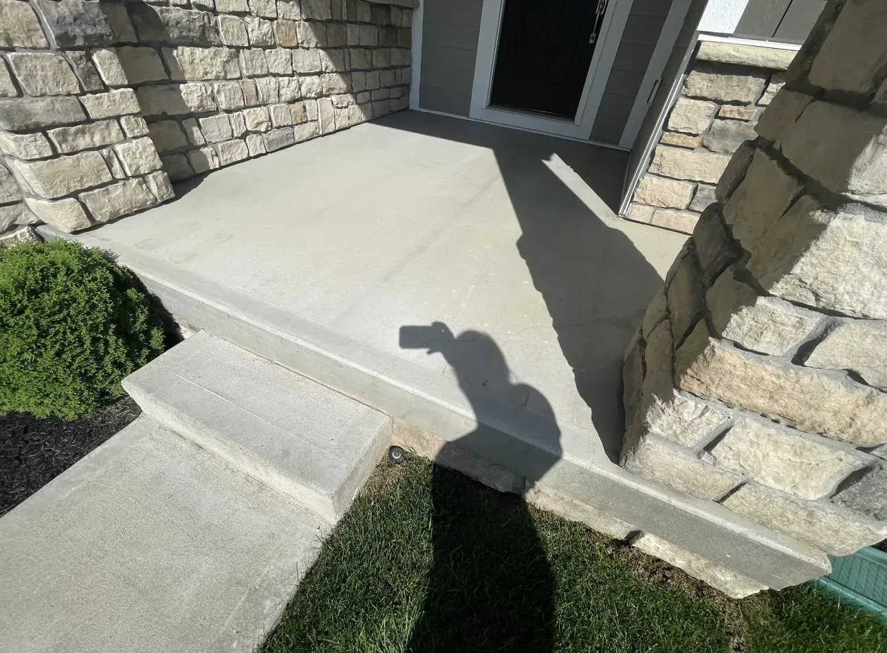Front porch concrete before coating, showing weathered surface in Central Indiana