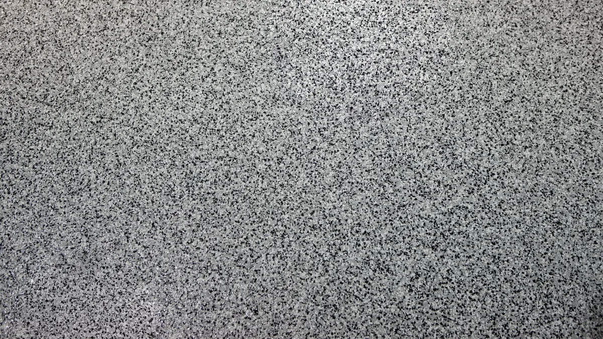 Polyaspartic garage floor coating being applied with decorative flake by Guy Coatings